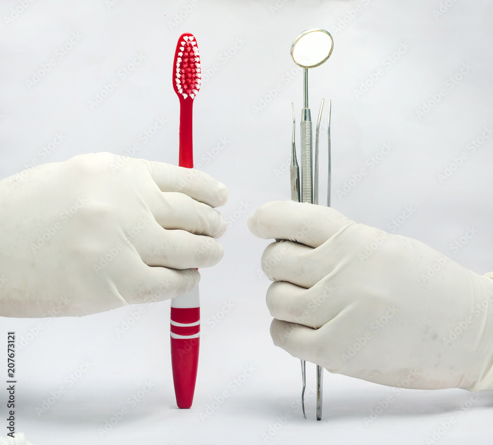 Holding Dental mirror and probe and tweezer amd toothbrush isolated in ...