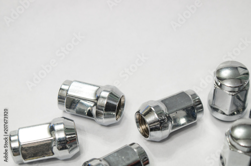 Car service, nut of fixture of a wheel of the car on a white background,