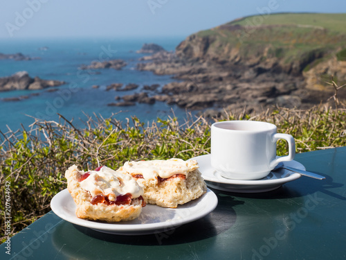 Bild auf Leinwand A traditional English cream tea including scones, jam and clotted cream by a coa