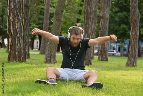 beard men listening music in park