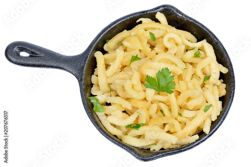 Spatzle in a pan with butter and parsley on white background