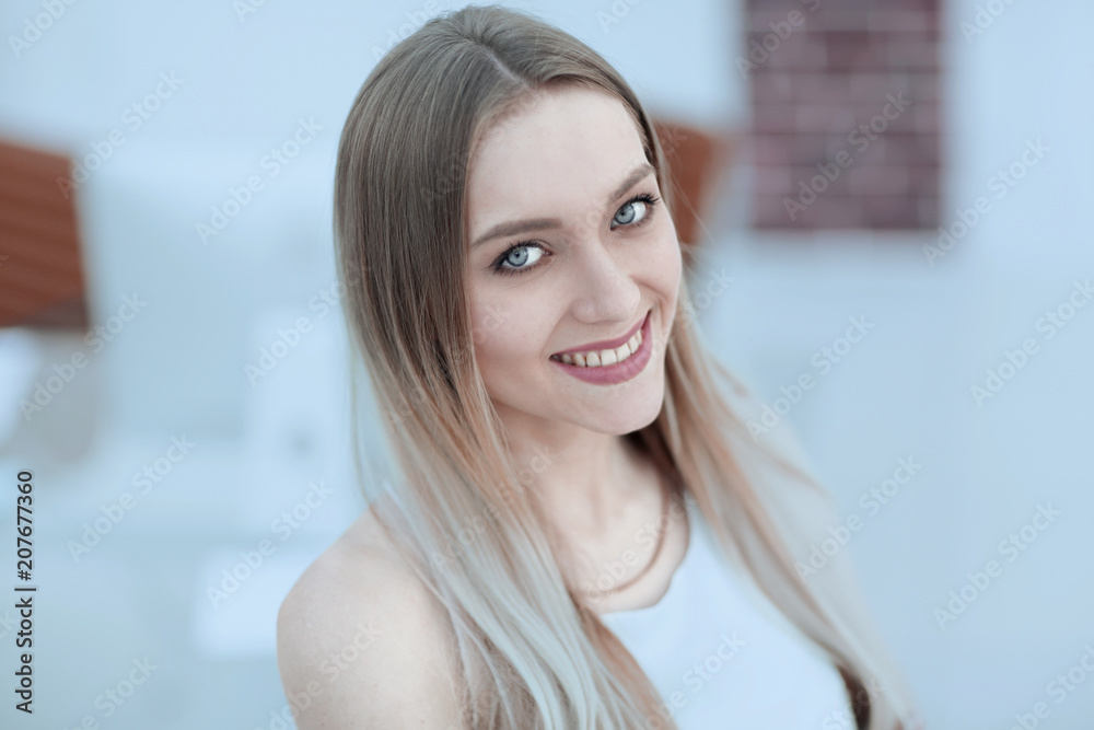 close-up portrait of a young woman on a blurred office background. close-up portrait of a young woman on a blurred office background.