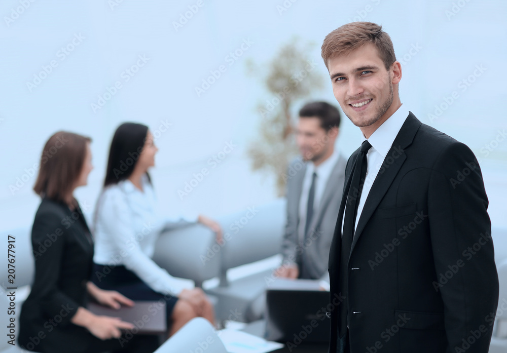 portrait of confident businessman on background of office. portrait of confident businessman on background of office.