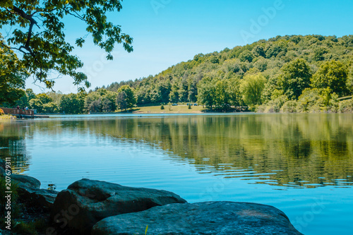 Looking out over the lake at Blue Spruce Park while a fisherman waits for a catch