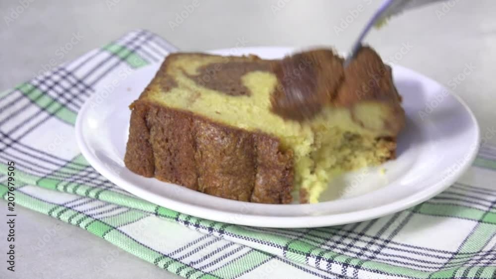 Taking a bite of a slice of delicious marble cake Taking a bite of a slice of delicious marble cake