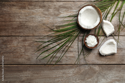 Composition with coconut oil on wooden background, top view. Healthy cooking
