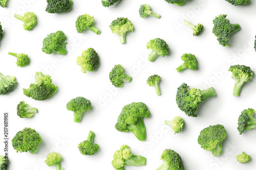 Flat lay composition with fresh green broccoli on light background