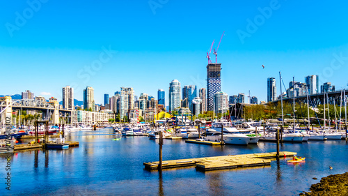 Skyline of the City of Vancouver, British Columbia, Canada with lots of boating activity at False Creek on a clear summer day
