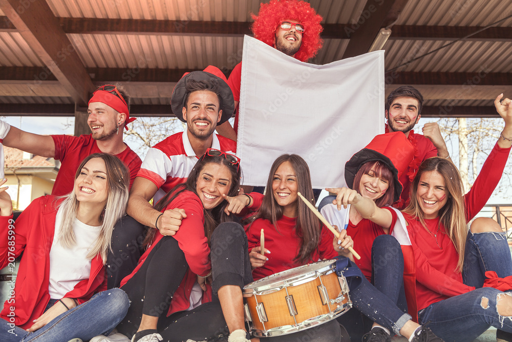 © Marino Bocelli - group of fans dressed in red color watching a sports event © Marino Bocelli - group of fans dressed in red color watching a sports event