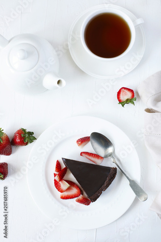 Piece of chocolate cake served with strawberries