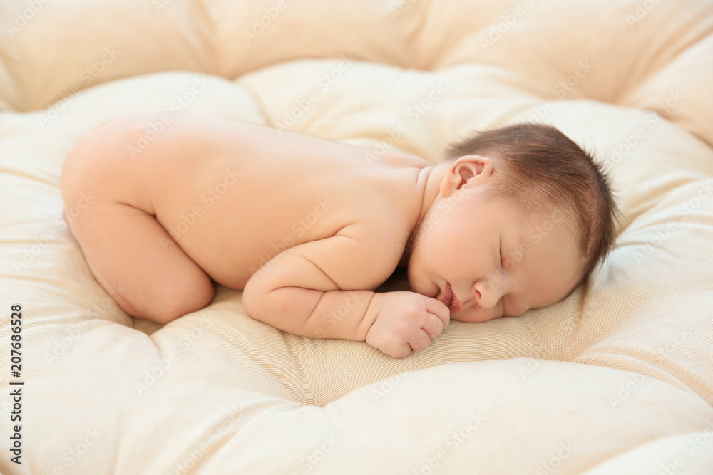 Adorable newborn baby sleeping on bed Adorable newborn baby sleeping on bed