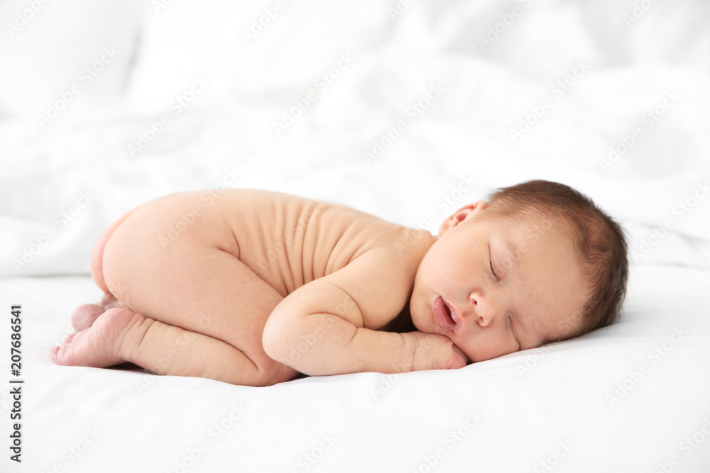 Adorable newborn baby sleeping on bed Adorable newborn baby sleeping on bed