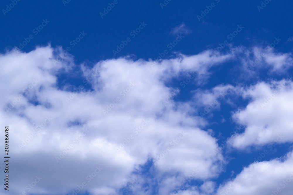 Dense clouds in a bright blue sky in the summer at noon. Dense clouds in a bright blue sky in the summer at noon.