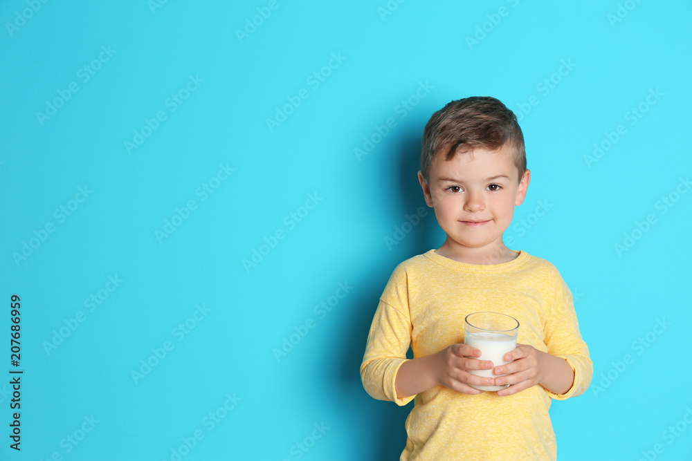 Cute little boy with glass of milk on color background Cute little boy with glass of milk on color background