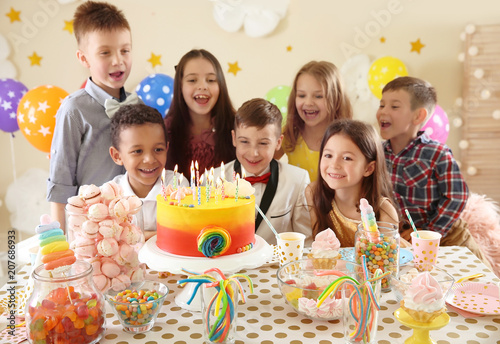 Cute children celebrating birthday at table indoors