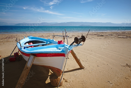 Fisherboat before tourist season at Kavos beach in Corfu, Greece photo