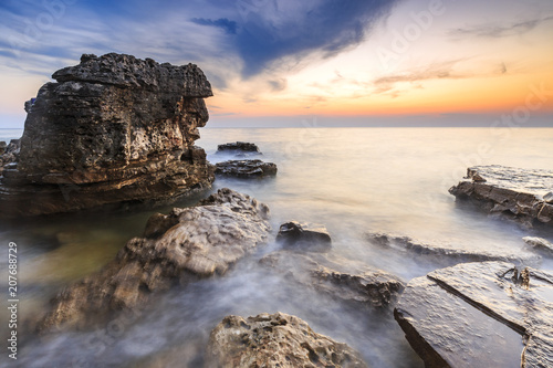 Enjoying the colorful sunset on a beach with rocks on the Adriatic Sea coast Istria Croatia © Sander Meertins