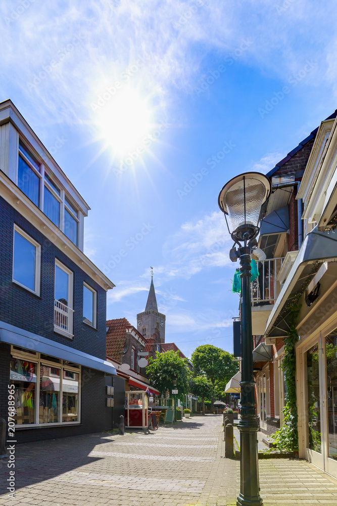 View at shopping street in Den Burg village on the wadden island Texel during Summer.