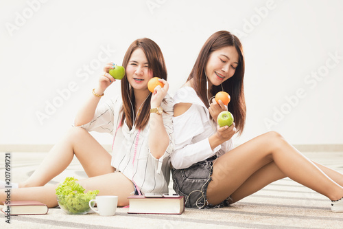 beautiful Asia teen girls holding vegetables  and fruits posing,make gestures with fun and happy. photo