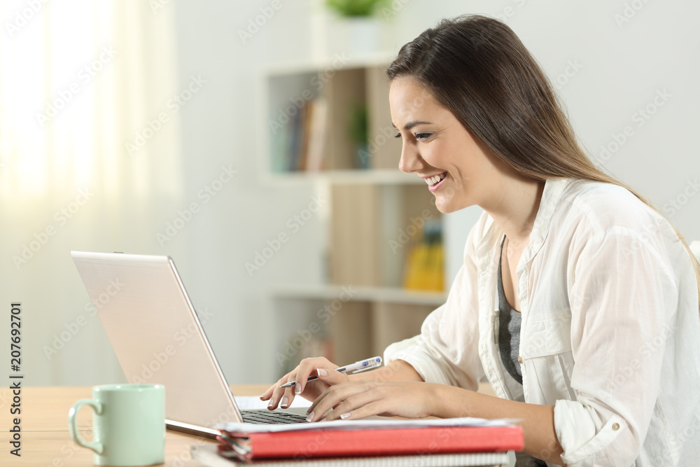 Student e-learning online at home with a laptop Student e-learning online at home with a laptop