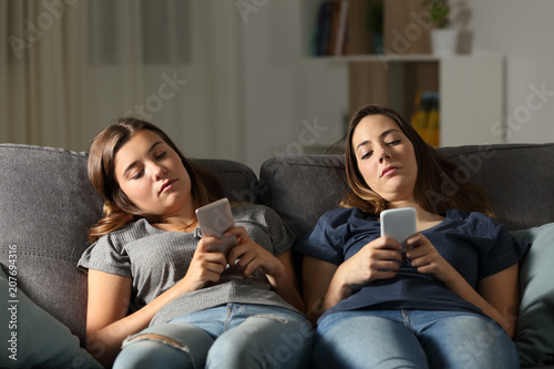 Bored friends using their smart phones