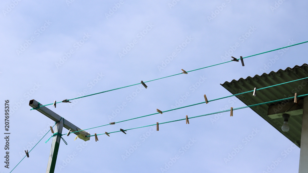 The empty clothesline and the washing tongs on the rooftop. The empty clothesline and the washing tongs on the rooftop.