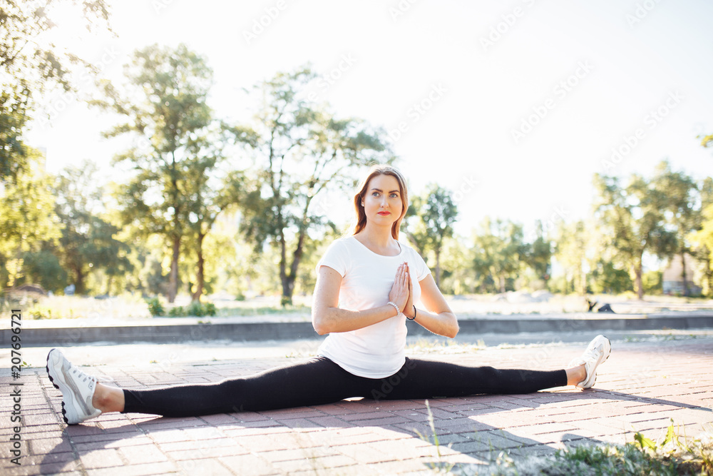 young flexible girl, sitting on the twine, stretched before training, advertising, text insertion
