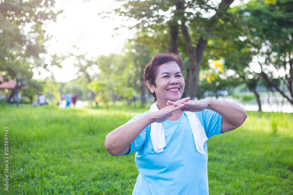 Senior Asian woman have happiness and have wellbeing life by exercise with freshness in the park, maintaining the health of an elderly woman in retirement concept. Senior Asian woman have happiness and have wellbeing life by exercise with freshness in the park, maintaining the health of an elderly woman in retirement concept.