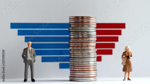 Bar charts and miniature people. The concept of gender inequality. photo