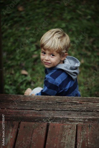 Photo of adorable young happy boy looking at camera.