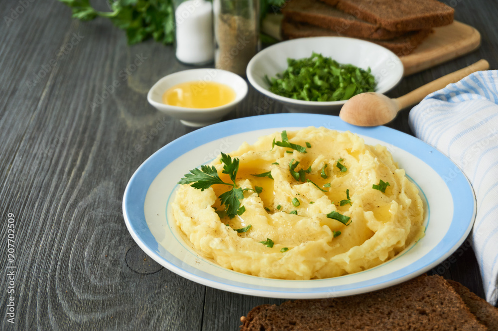 Mashed potatoes with fresh parsley and butter on a plate Mashed potatoes with fresh parsley and butter on a plate