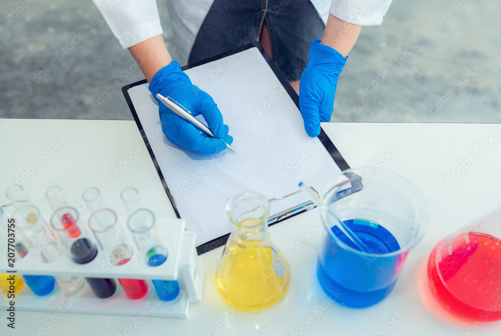 Chemist Researcher Scientist in Lab Coat Uniform Taking Note and Analizing Data Report on Clipboard, Medicine Research Specialist in Laboratory While Experiment Biochemical Structure of Pharmaceutical Chemist Researcher Scientist in Lab Coat Uniform Taking Note and Analizing Data Report on Clipboard, Medicine Research Specialist in Laboratory While Experiment Biochemical Structure of Pharmaceutical