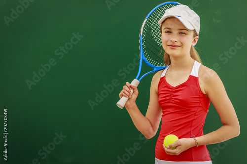 Tennis young girl player on court. © Gorilla