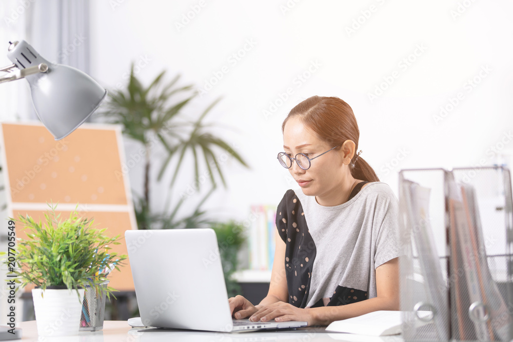 Young asian business woman working with computer . Young asian business woman working with computer .