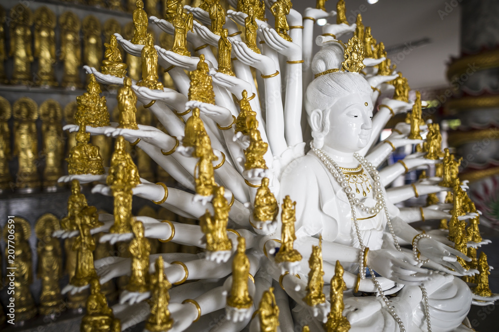 Fototapeta premium Golden thousand hands Guanyin statue at Hat Yai Thailand Asia