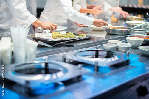Team of chef helping each other to finish the good food for customer
