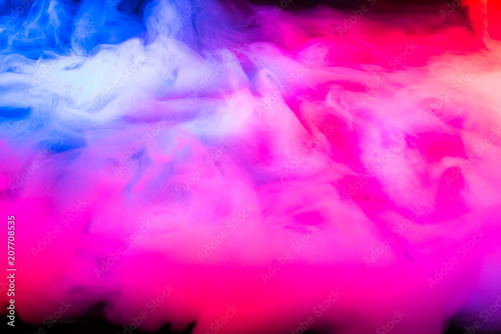 Multi-colored smoke in the form of a cloud on a black background