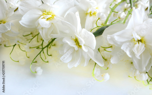 gentle romantic soft light floral composition of white terry flowers of daffodils and lilies of the valley. Pastel refined luxury  postcard  greeting  background