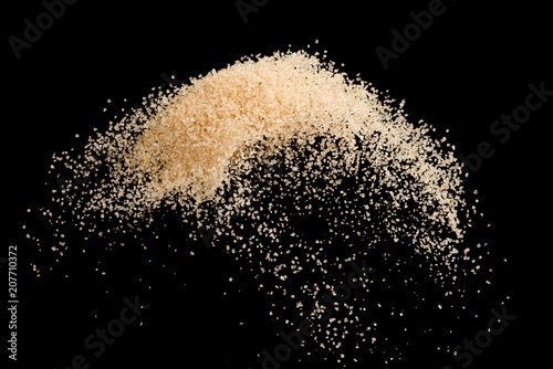 Canvas-taulu Brown sugar flying explosion splash isolated on black background  ,throwing free