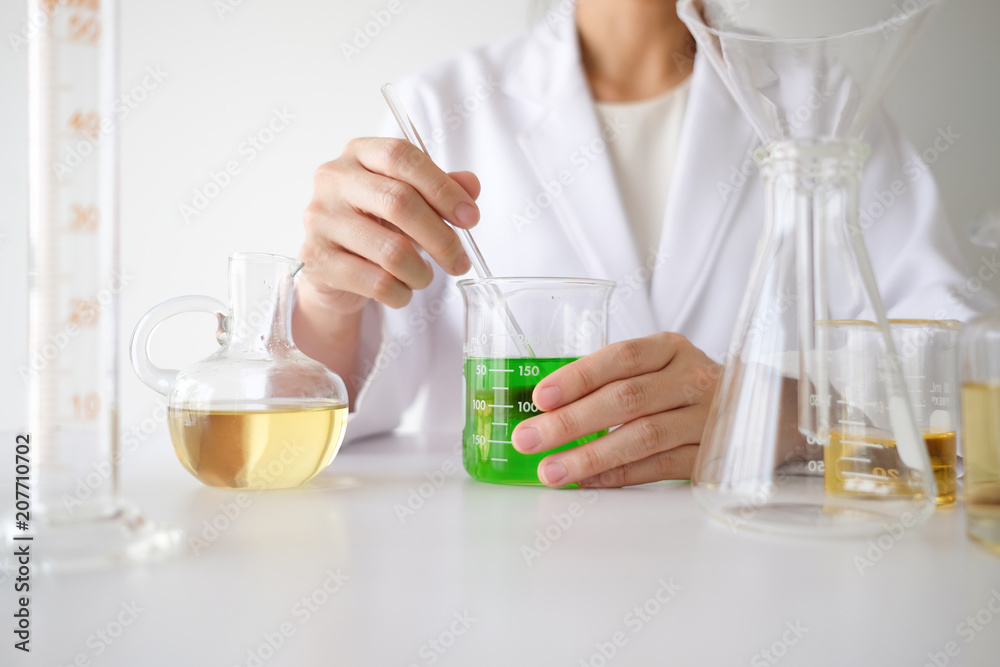 doctor woman scientist making herbal medicine in lab with herb leaves vitamin supplements mineral alternative treatment research. doctor woman scientist making herbal medicine in lab with herb leaves vitamin supplements mineral alternative treatment research.