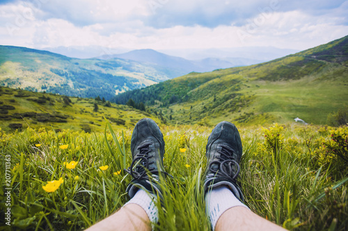 hiking boots having fun and enjoying wonderful breathtaking mountain view. Freedom concept.