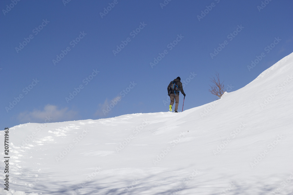 hikers walking in the snow in mountain