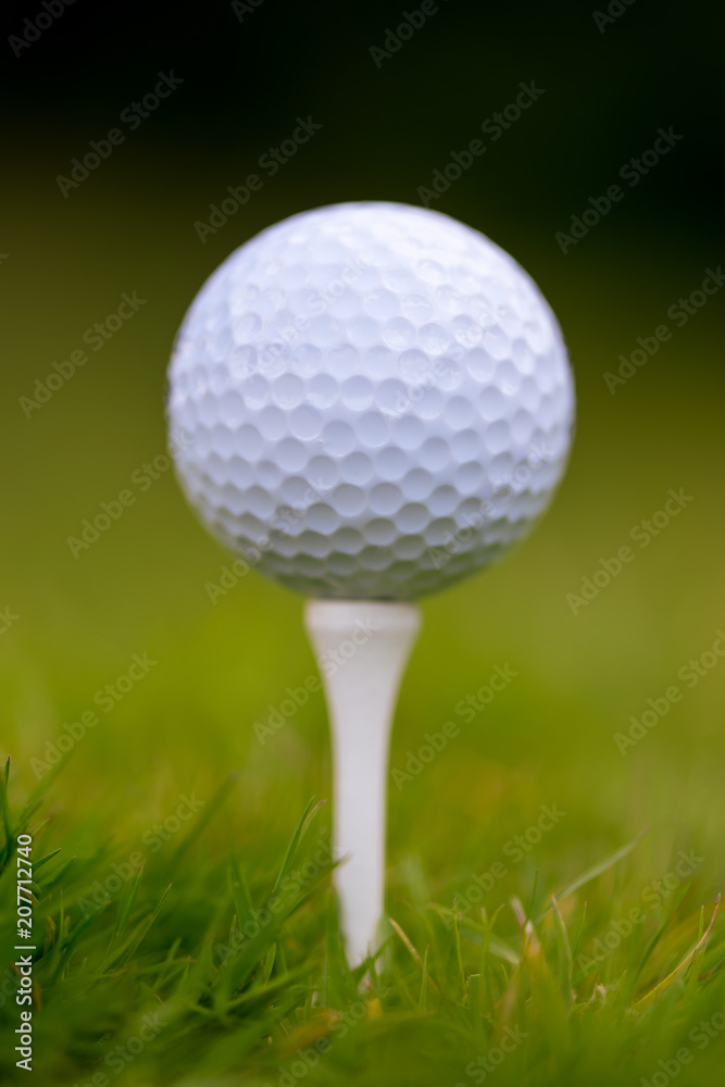 Golf ball on tee ready to be shot Golf ball on tee ready to be shot