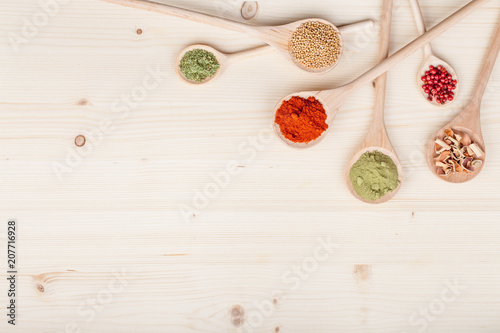 spices and herbs on kitchen wooden table background with copy space for text. food, cooking and restaurant concept. flat lay colorful composition, top view