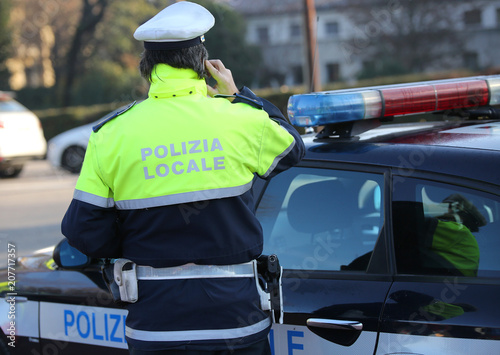 italian police car and policeman with the text POLIZIA LOCALE th