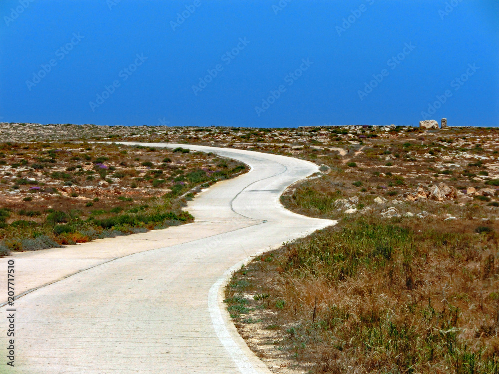 Winding road with many curves that leads to the sea