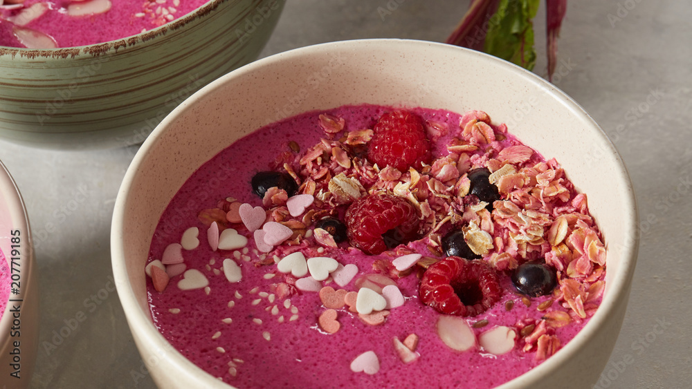 Bowl with breakfast pink smoothie from granola and almond. Bowl with breakfast pink smoothie from granola and almond.