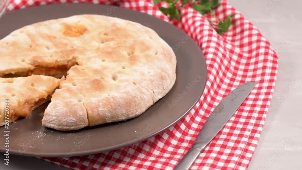 Italian food, pizza calzone with tomato, spinach and cheese on wooden background. Italian food, pizza calzone with tomato, spinach and cheese on wooden background.