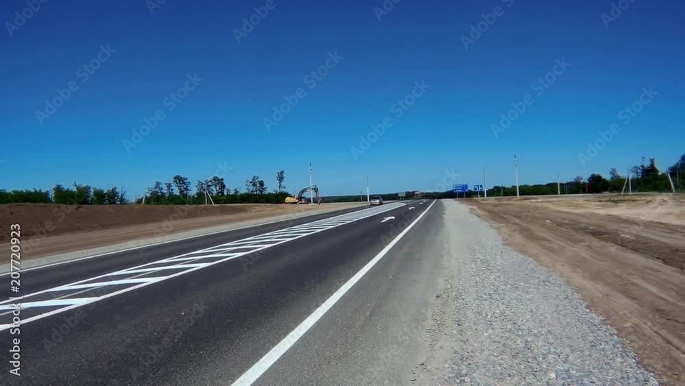 cars driving on an asphalt road in the summer cars driving on an asphalt road in the summer