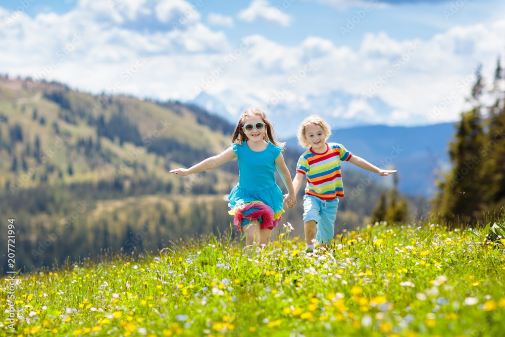 Fototapeta premium Children hiking in Alps mountains. Kids outdoor.